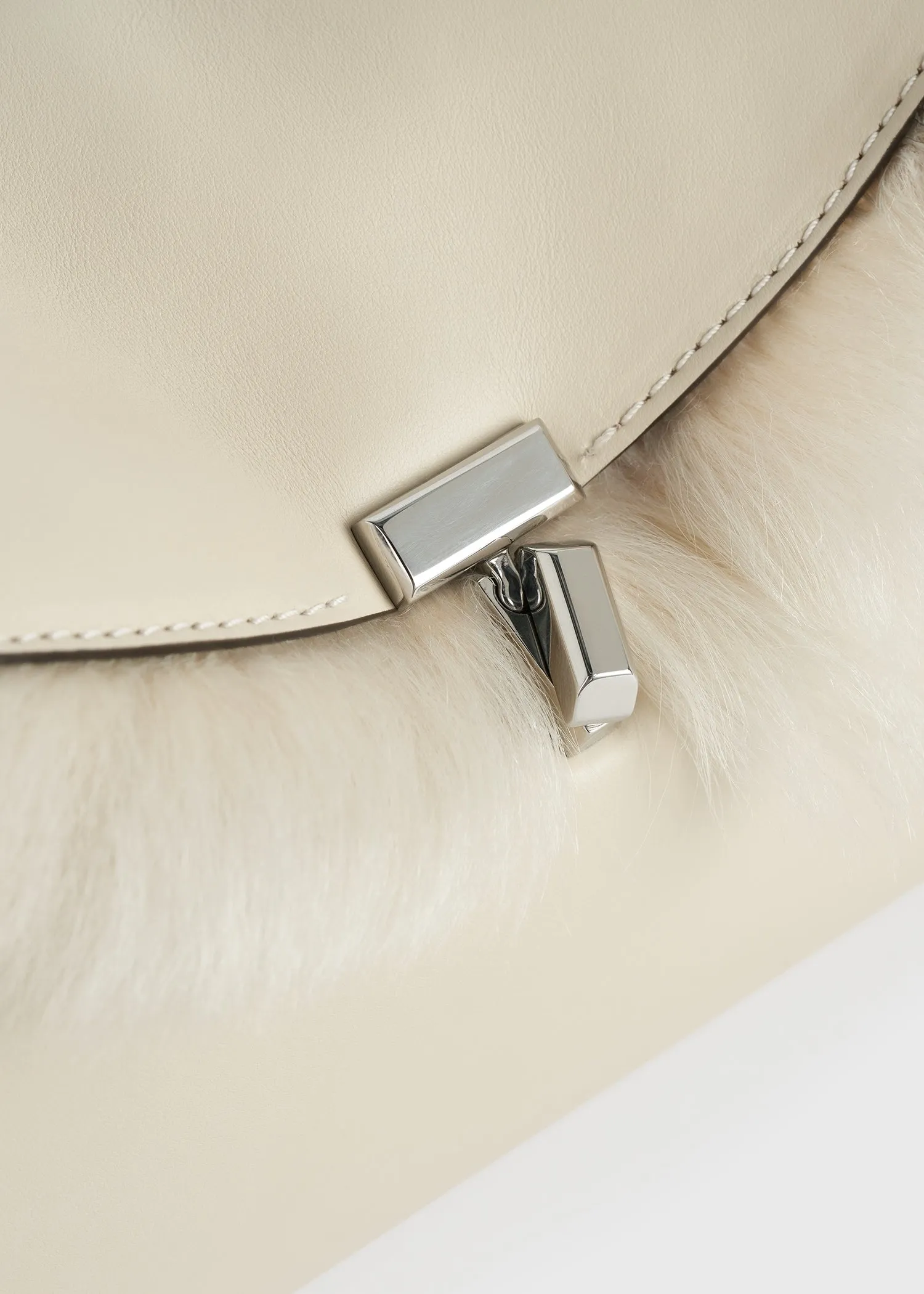 Shearling T-Lock clutch ecru